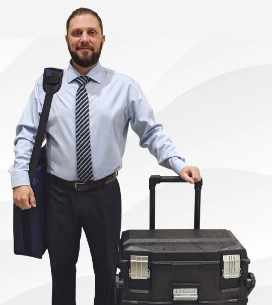 Martin Dube with his mobile hearing equipment case